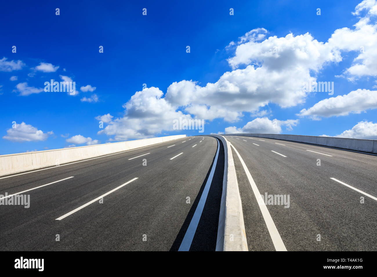 Empty asphalt road and blue sky with white clouds scene Stock Photo - Alamy