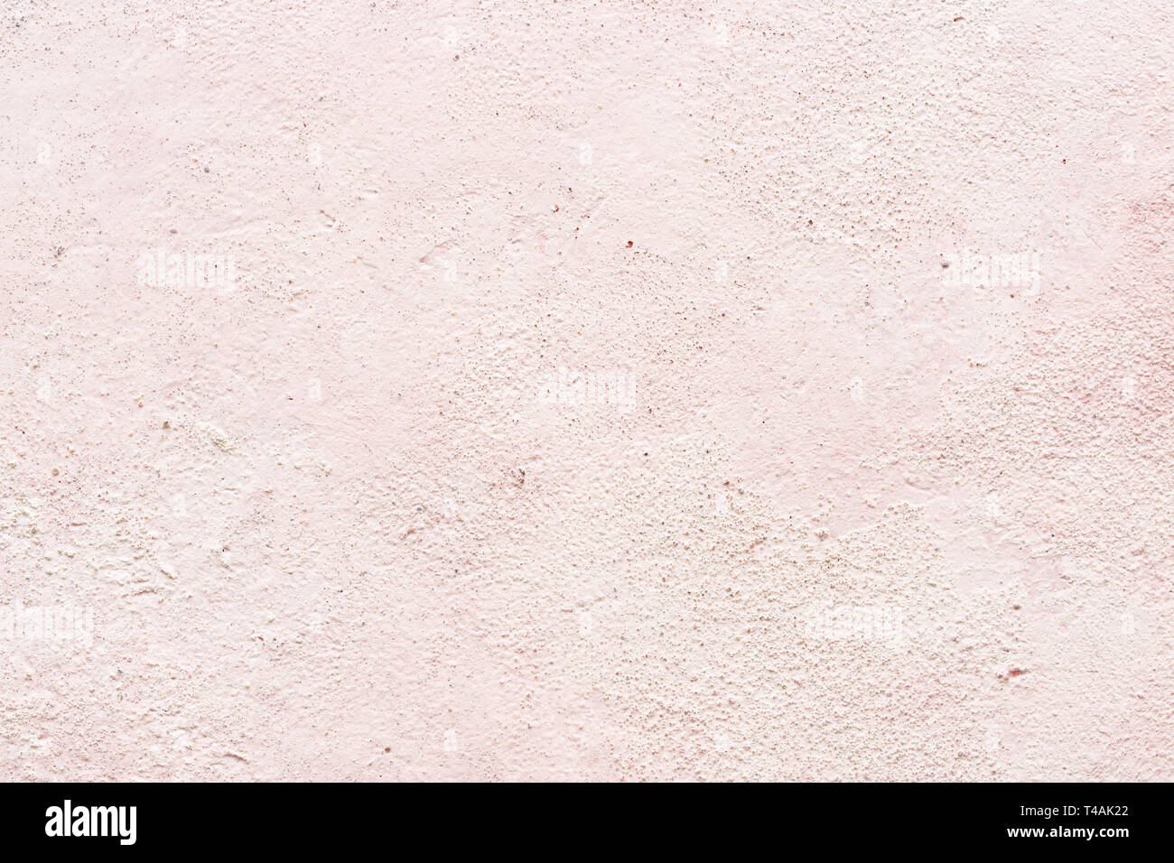 Light pink texture of plaster or stucco wall, close-up. Gentle background, interior decor. Stock Photo