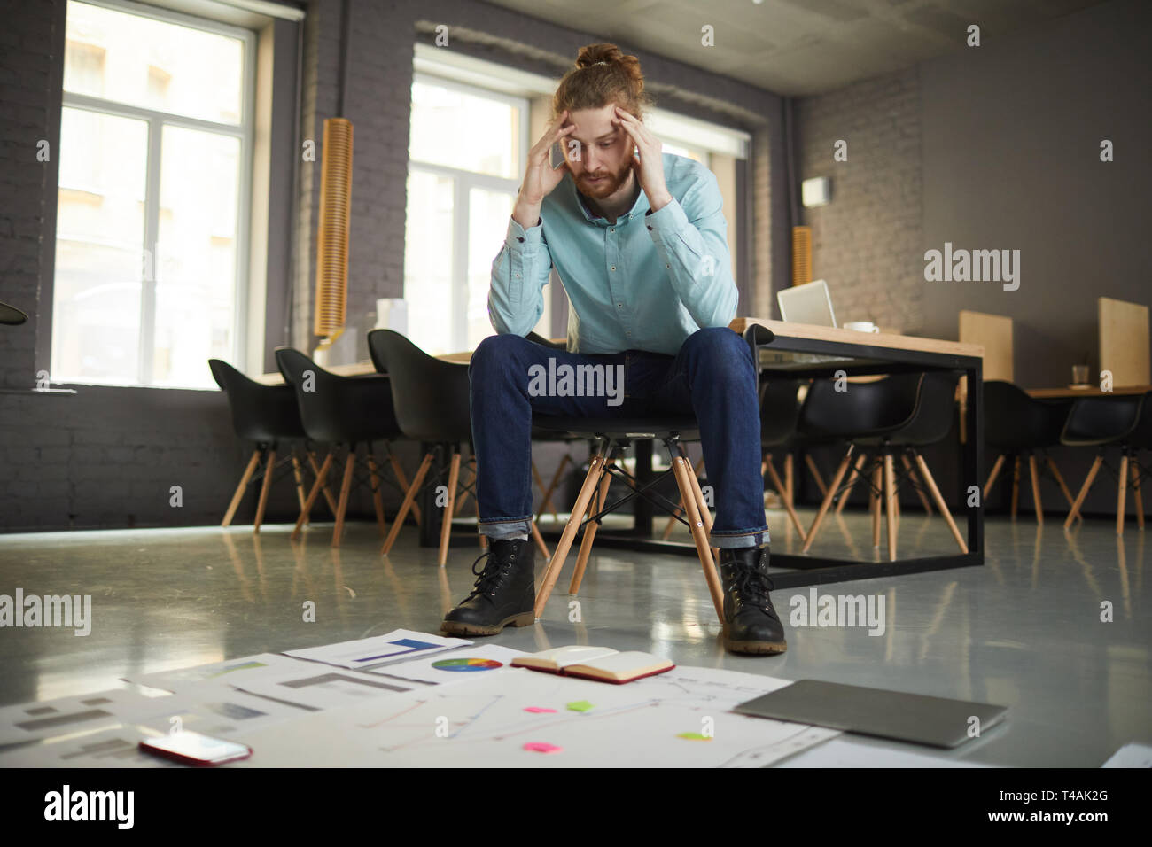 Puzzled Businessman Looking at Documents Stock Photo