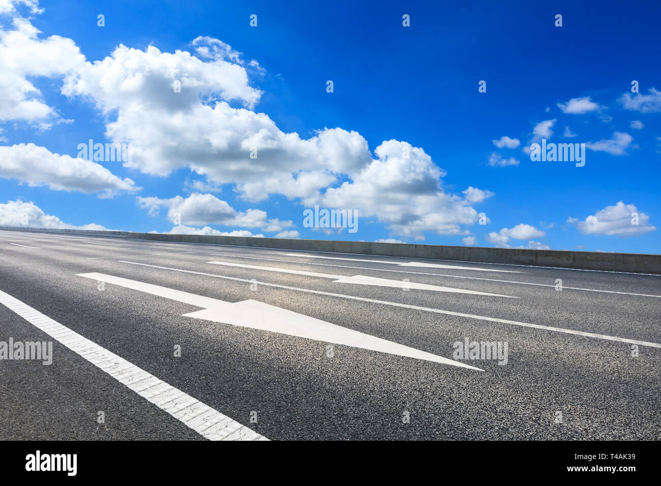 Empty asphalt road and blue sky with white clouds scene Stock Photo - Alamy