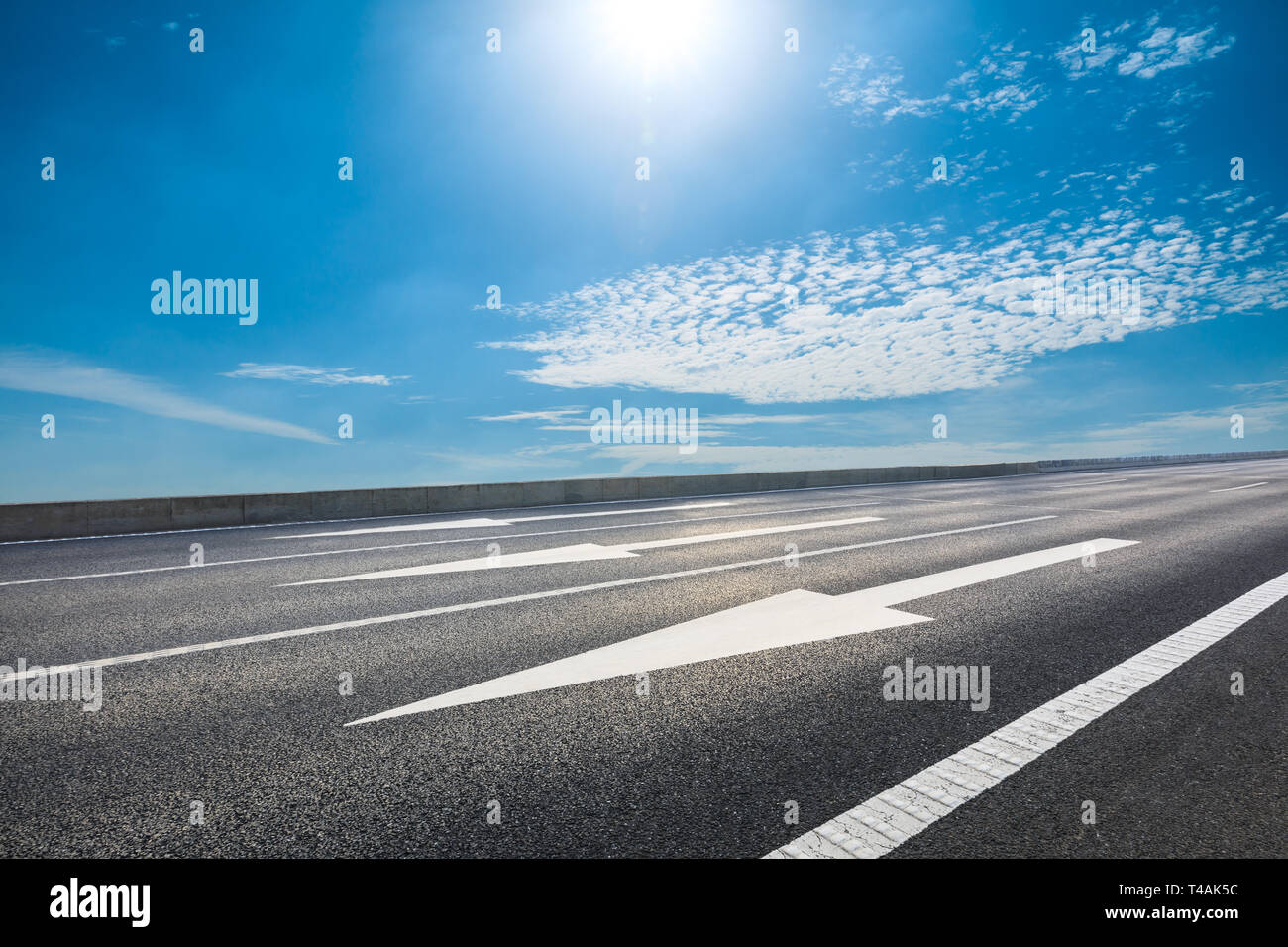 Empty asphalt road and blue sky with white clouds scene Stock Photo - Alamy