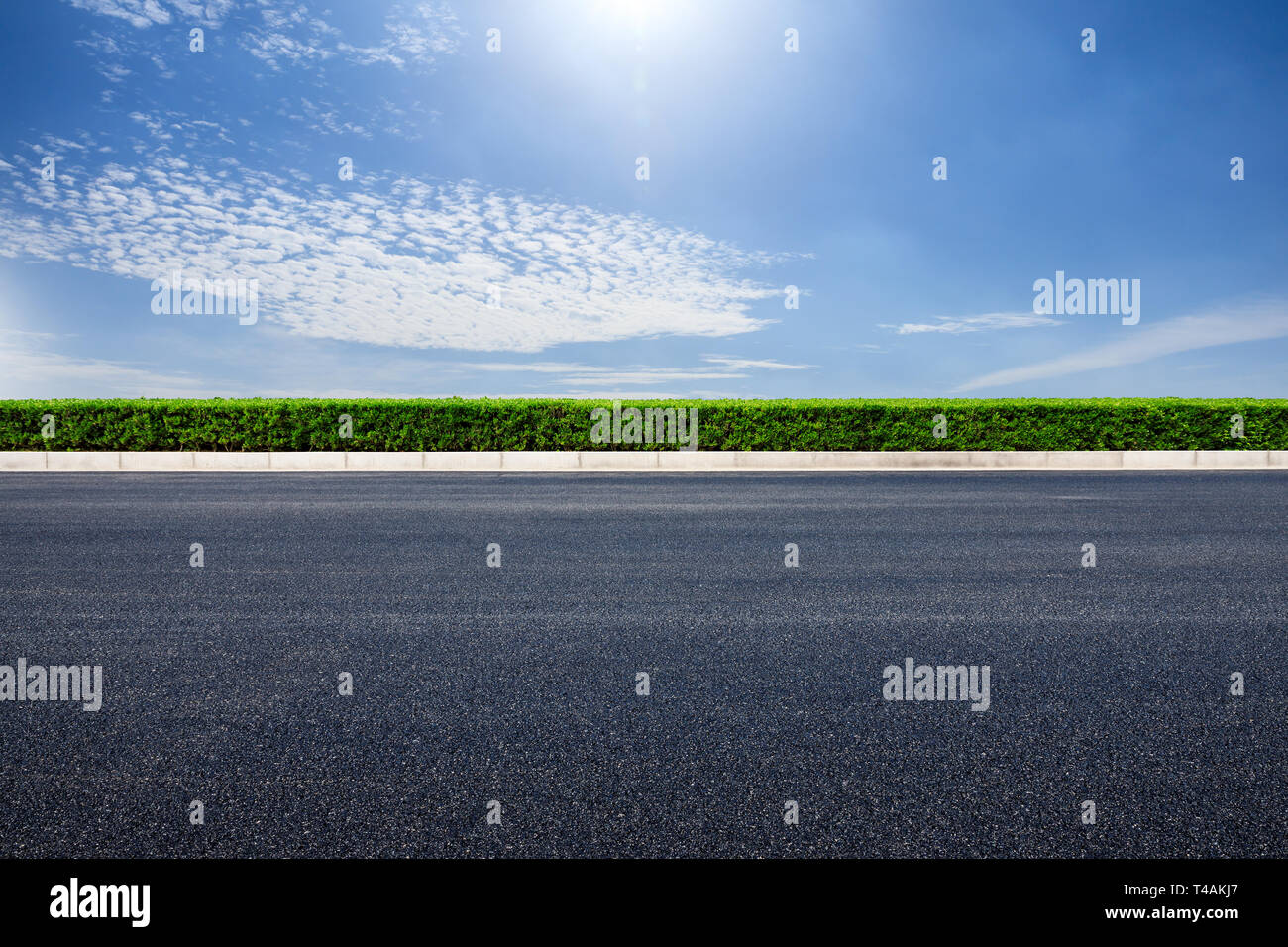 Empty asphalt road and blue sky with white clouds scene Stock Photo - Alamy