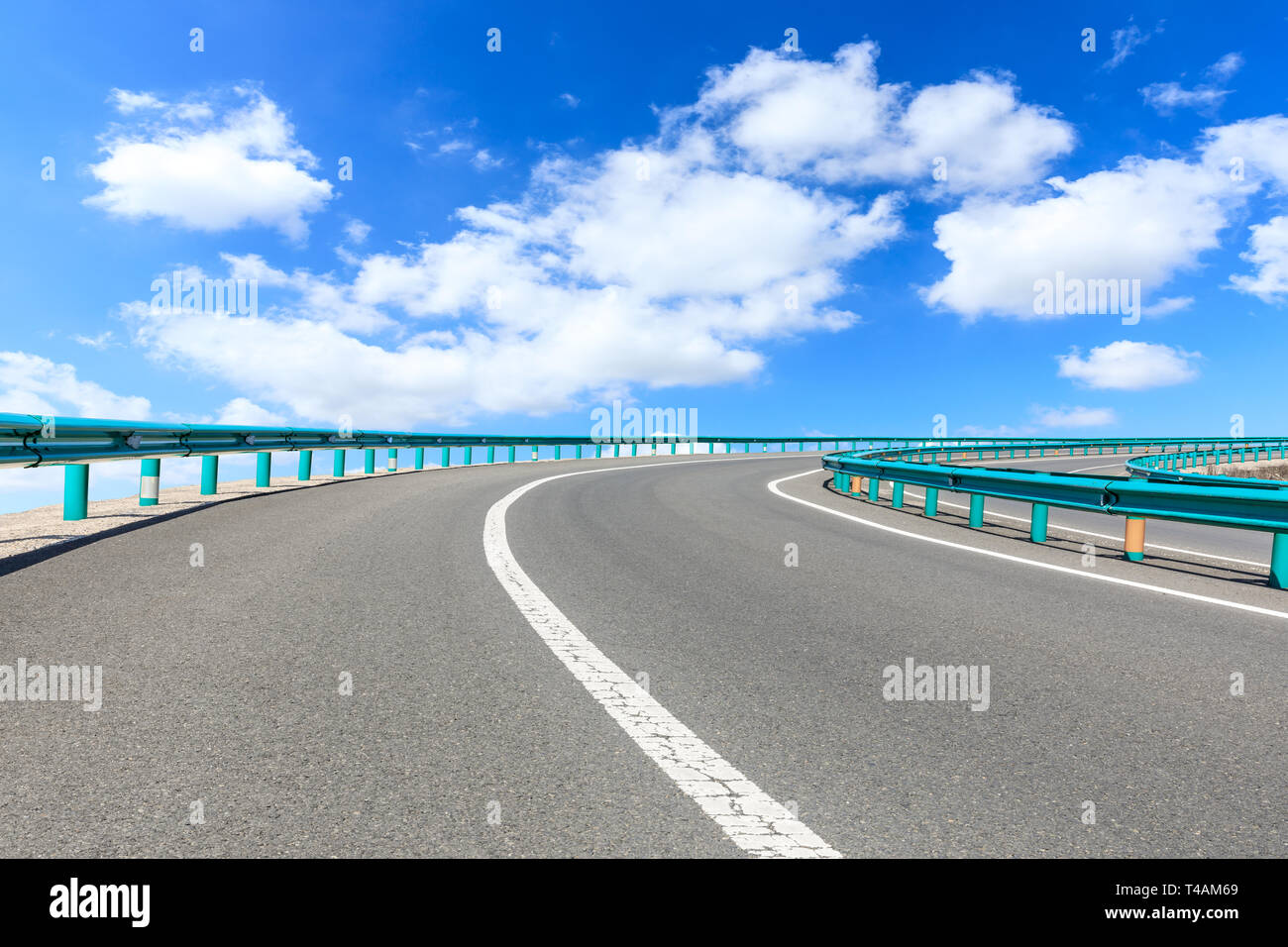 Empty asphalt road and blue sky with white clouds scene Stock Photo - Alamy