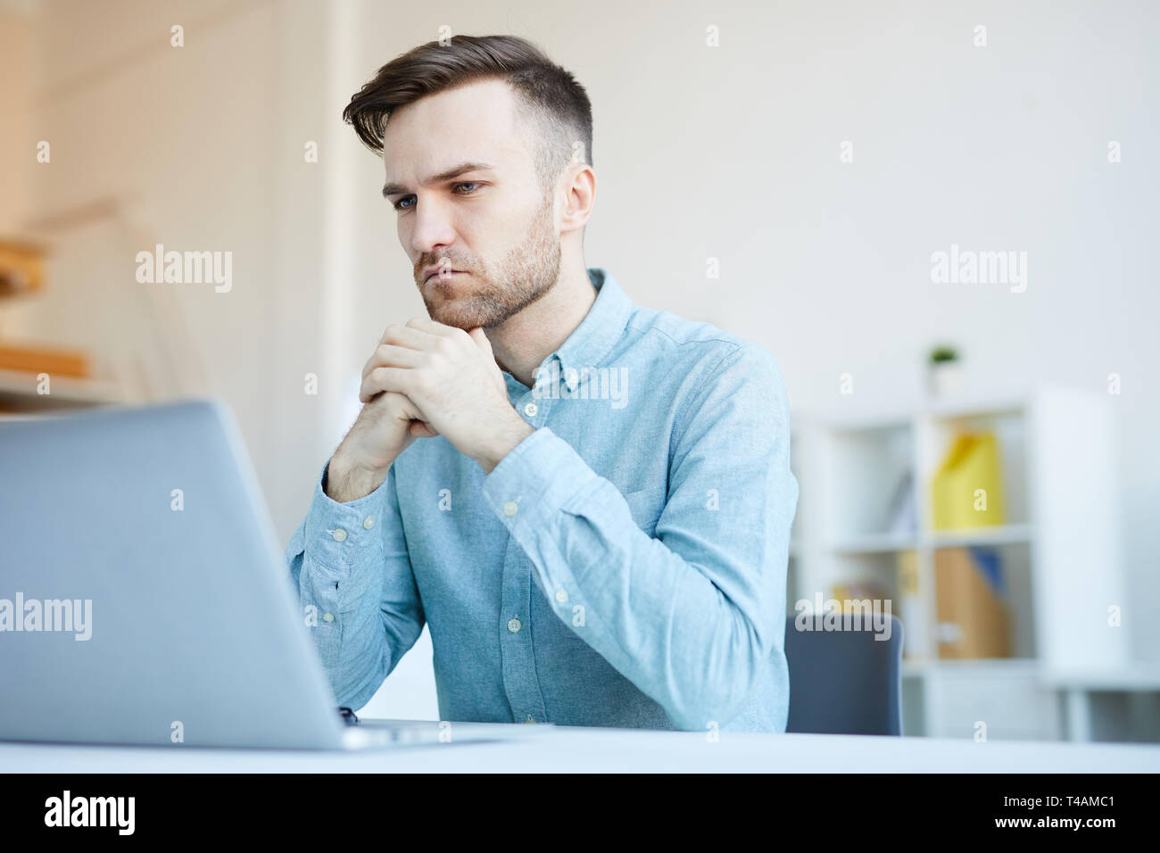 Pensive Man Using Laptop Stock Photo