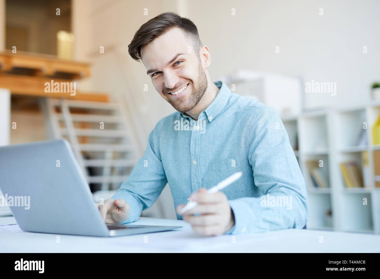 Smiling Man Using Laptop Stock Photo