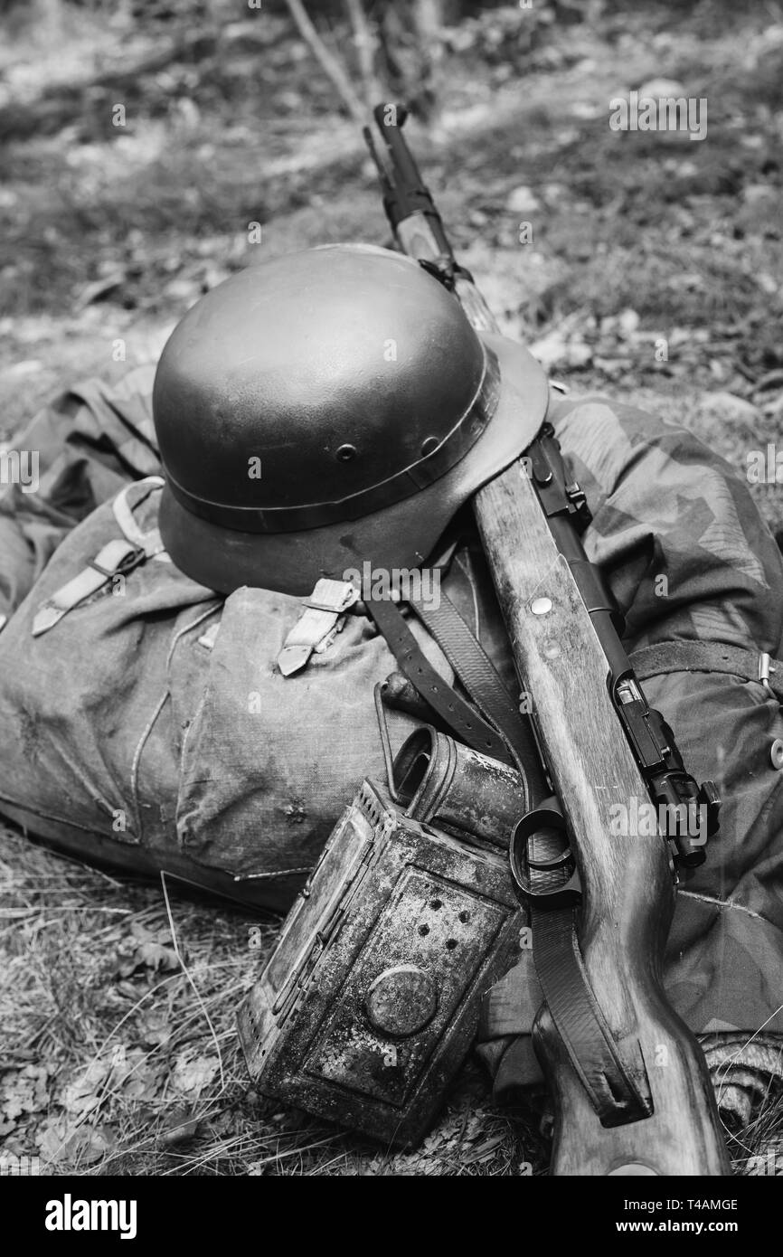 World War II German Wehrmacht Soldier Ammunition Of World War II On Ground.  WWII Military Helmet, Lights, Rifle Mauser Karabiner 98K. Photo In Black  Stock Photo