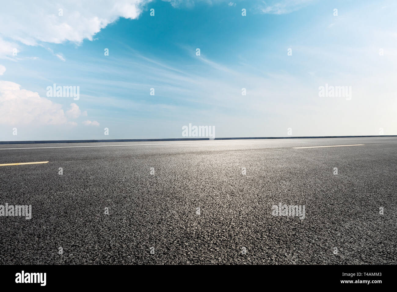 Empty asphalt road and blue sky with white clouds scene Stock Photo - Alamy