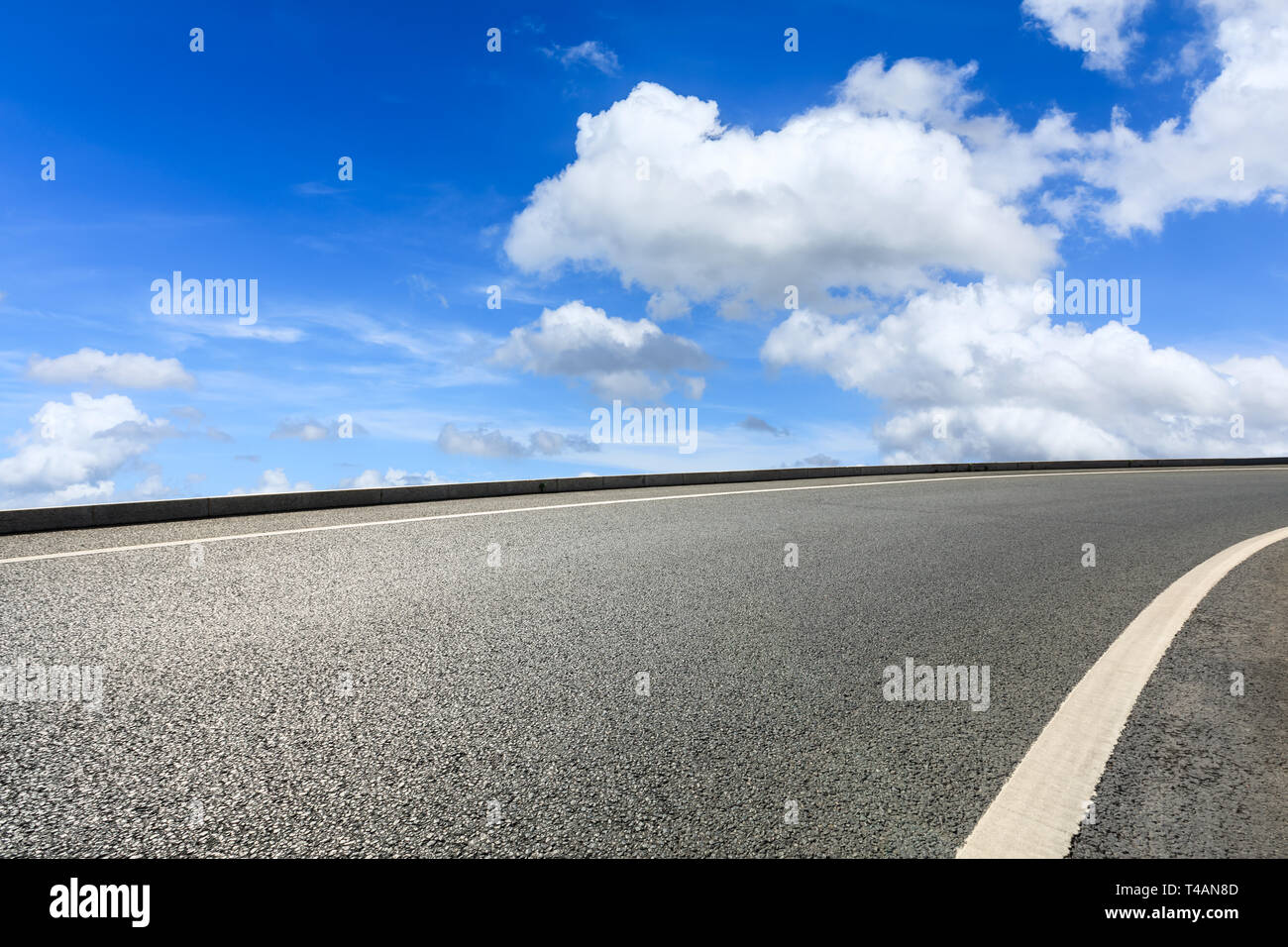 Empty asphalt road and blue sky with white clouds scene Stock Photo - Alamy