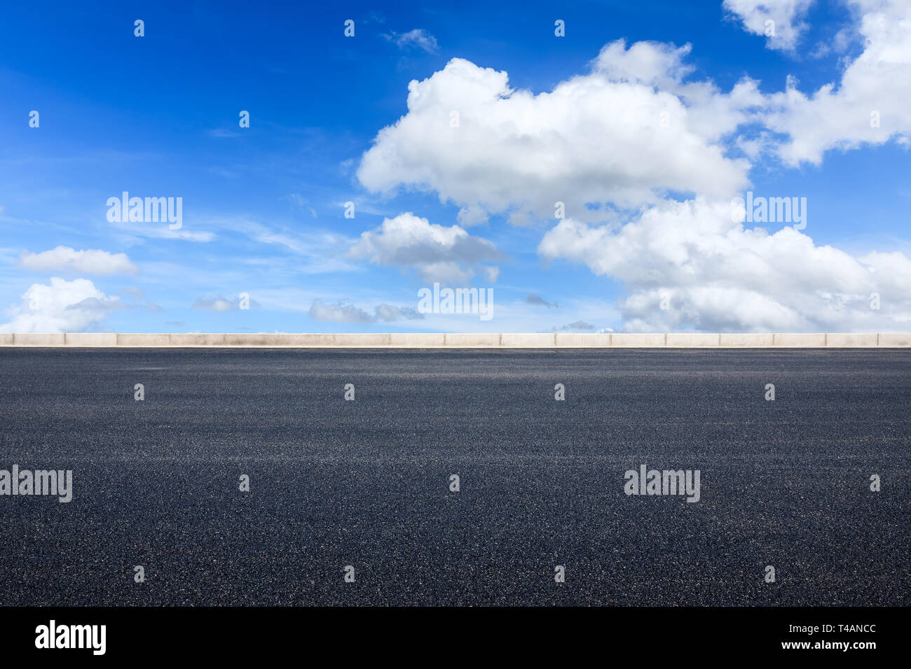Empty asphalt road and blue sky with white clouds scene Stock Photo - Alamy