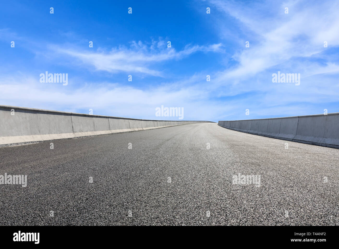 Empty asphalt road and blue sky with white clouds scene Stock Photo - Alamy
