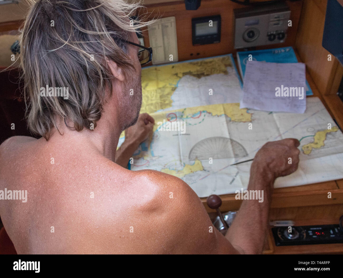 Sailor in front of compass chart chart table on compass Stock Photo