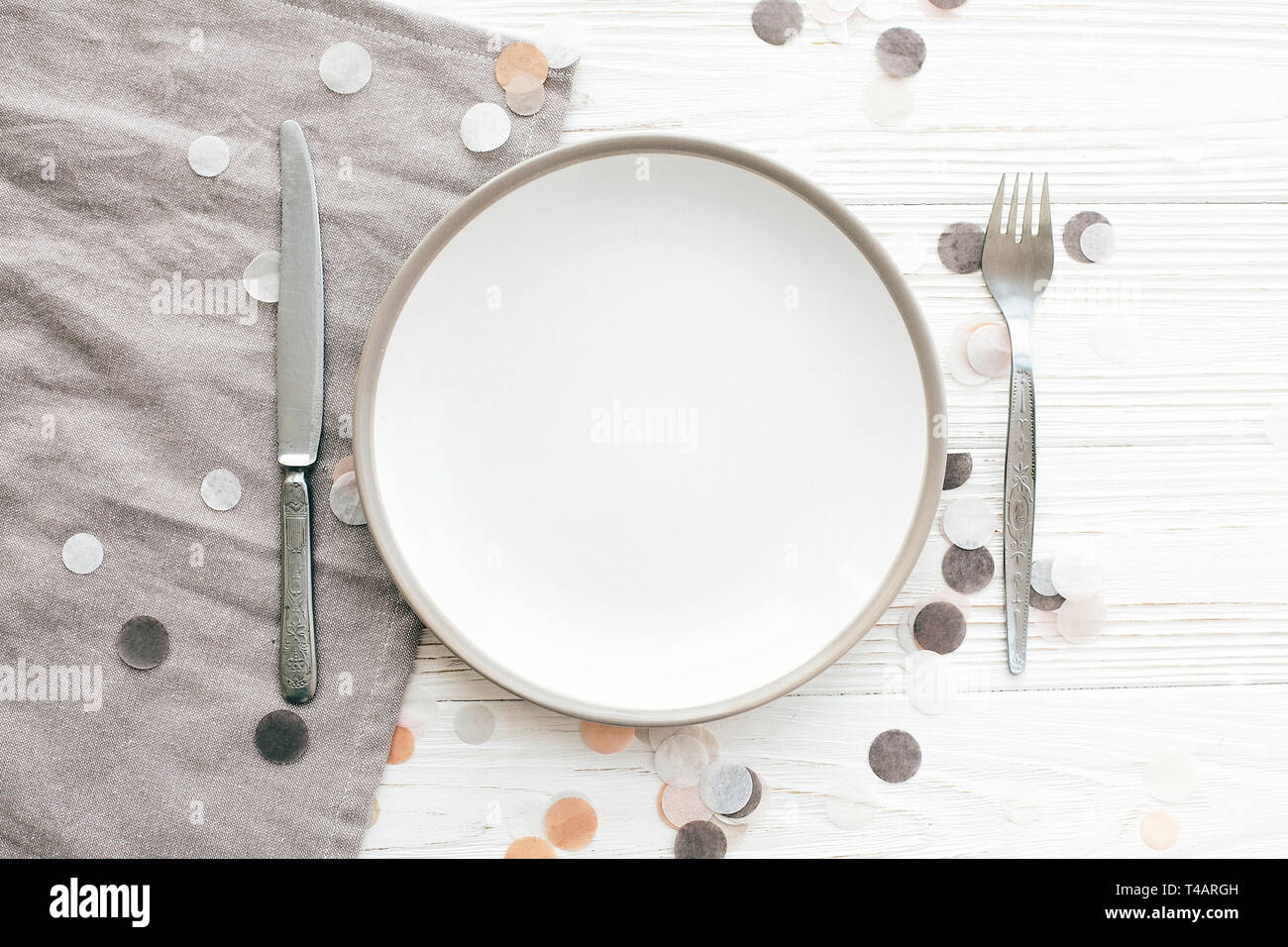 Stylish empty plate with vintage fork and knife on napkin on white ...