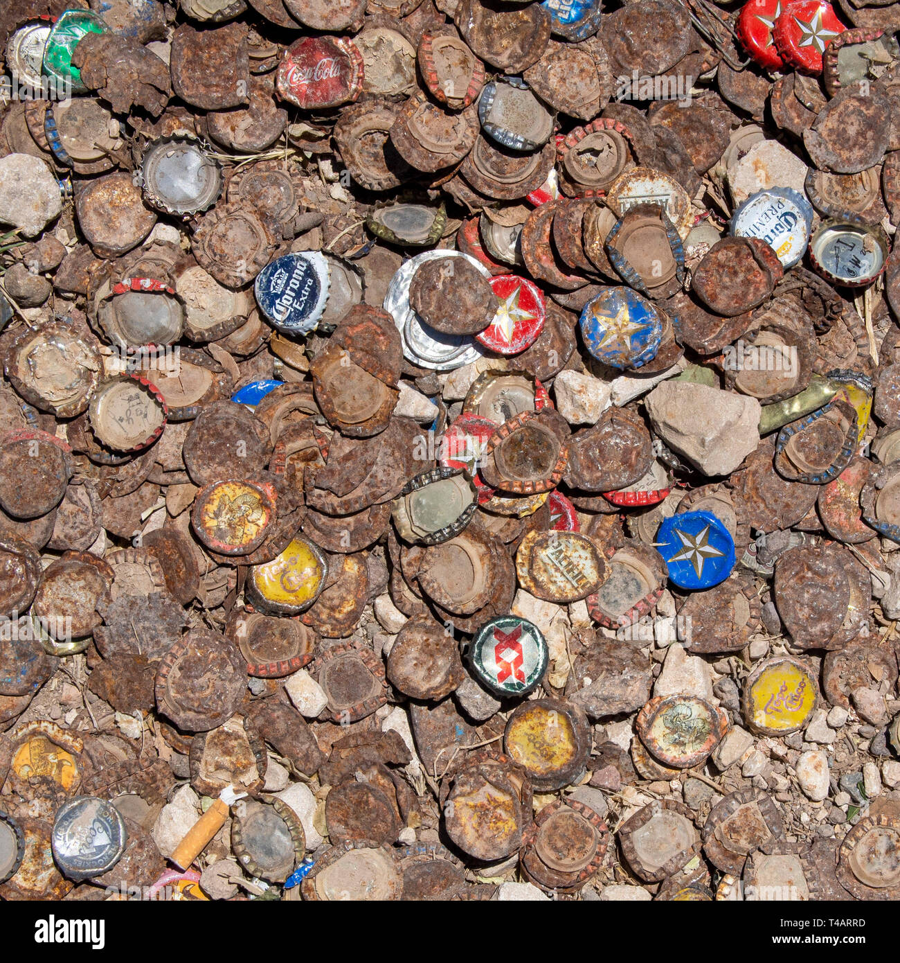 Beer bottles caps covering the backyard of a bar in Marfa, Texas. Stock Photo