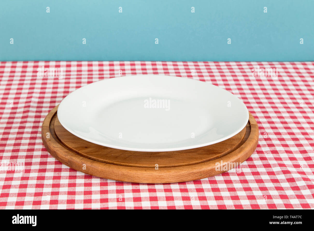 White plate and a cutting board on the table Stock Photo