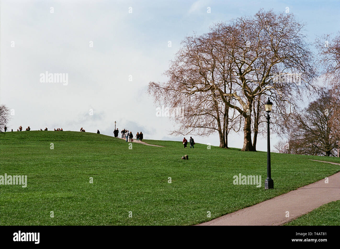 Walkers on Primrose Hill, North London UK, in springtime Stock Photo