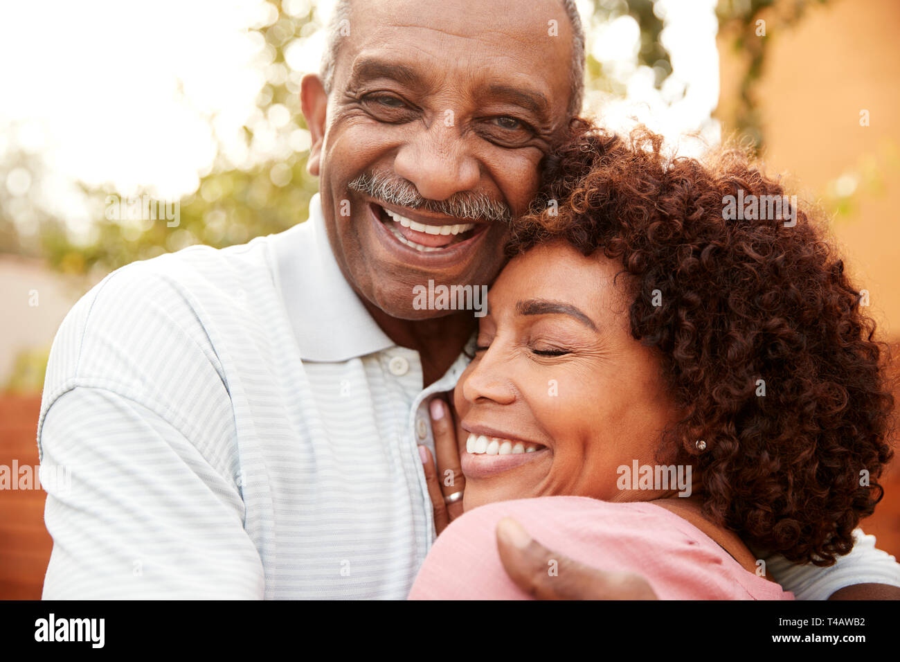 Senior black man and his middle aged daughter embracing, close up Stock Photo