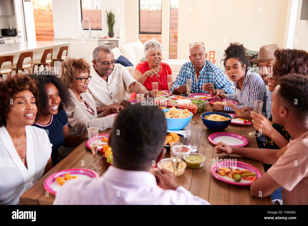Three generation black family sitting at dinner table celebrating together,close up Stock Photo