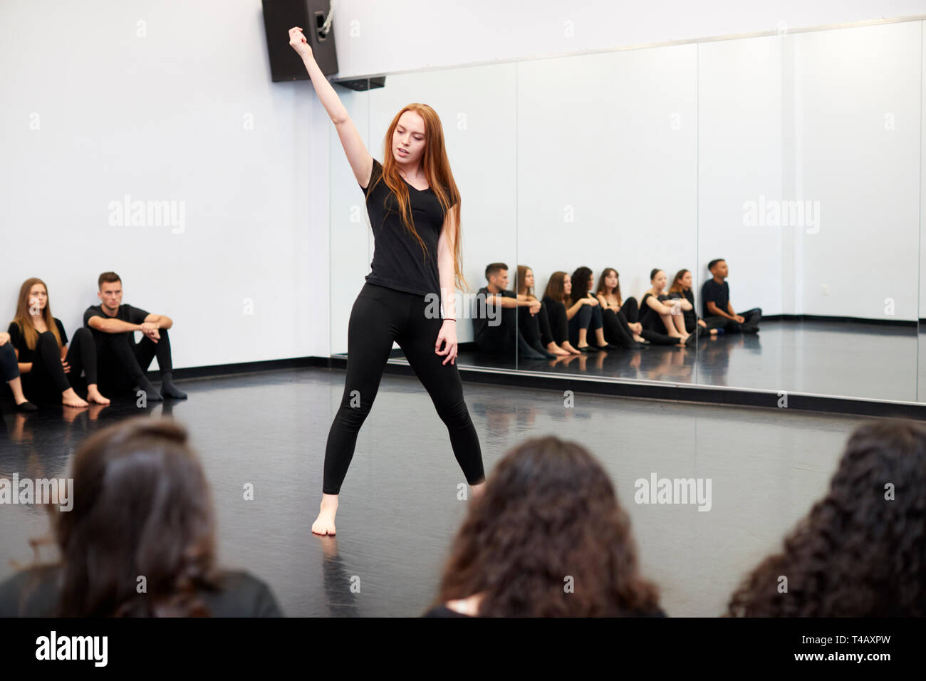 Female Student At Performing Arts School Performs Street Dance For Class And Teacher In Dance Studio Stock Photo
