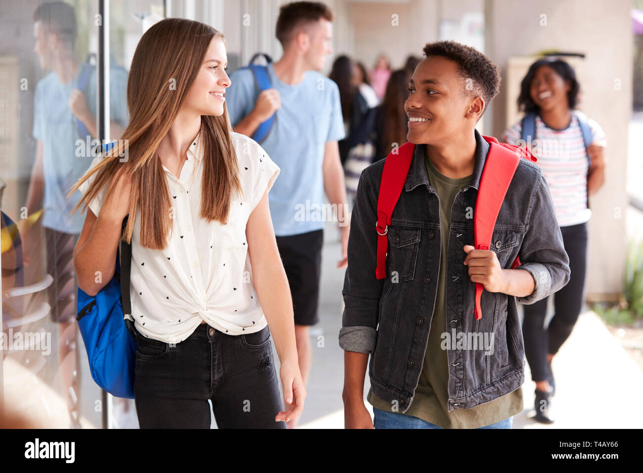 Group Of Smiling Male And Female College Students Walking In School ...