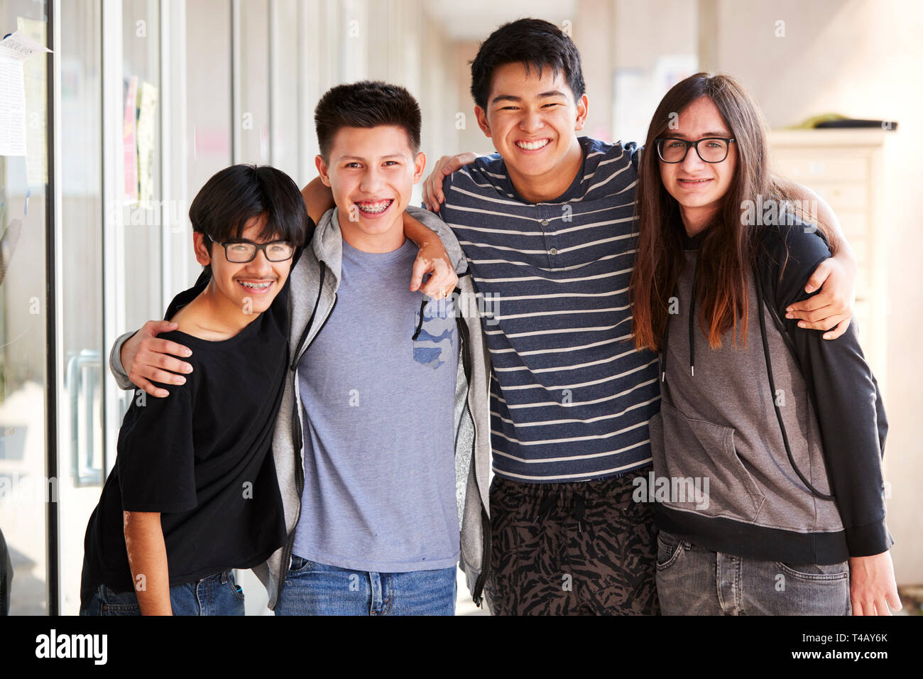 Portrait Of Smiling Male College Student Friends In Corridor Of ...