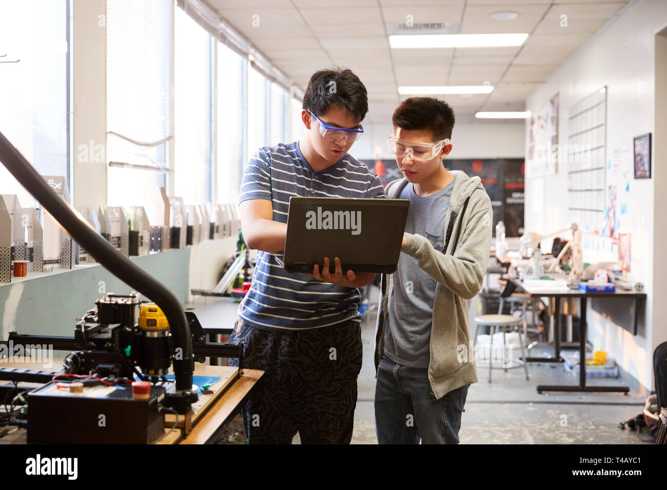 Two Male College Students Using Laptop Computer In Science Robotics Or