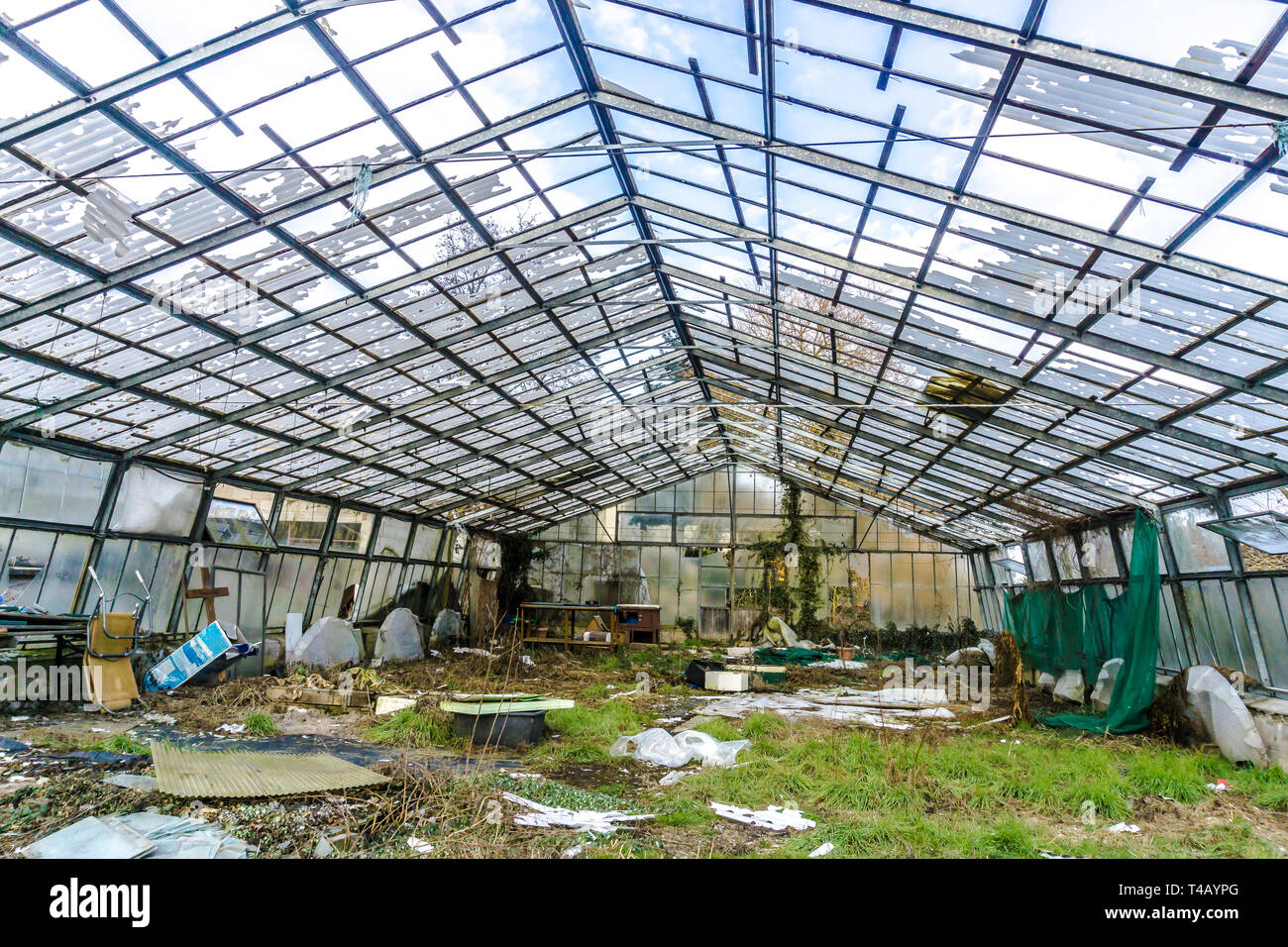 Greenhouse with broken glass, the construction is clearly visible Stock Photo Alamy