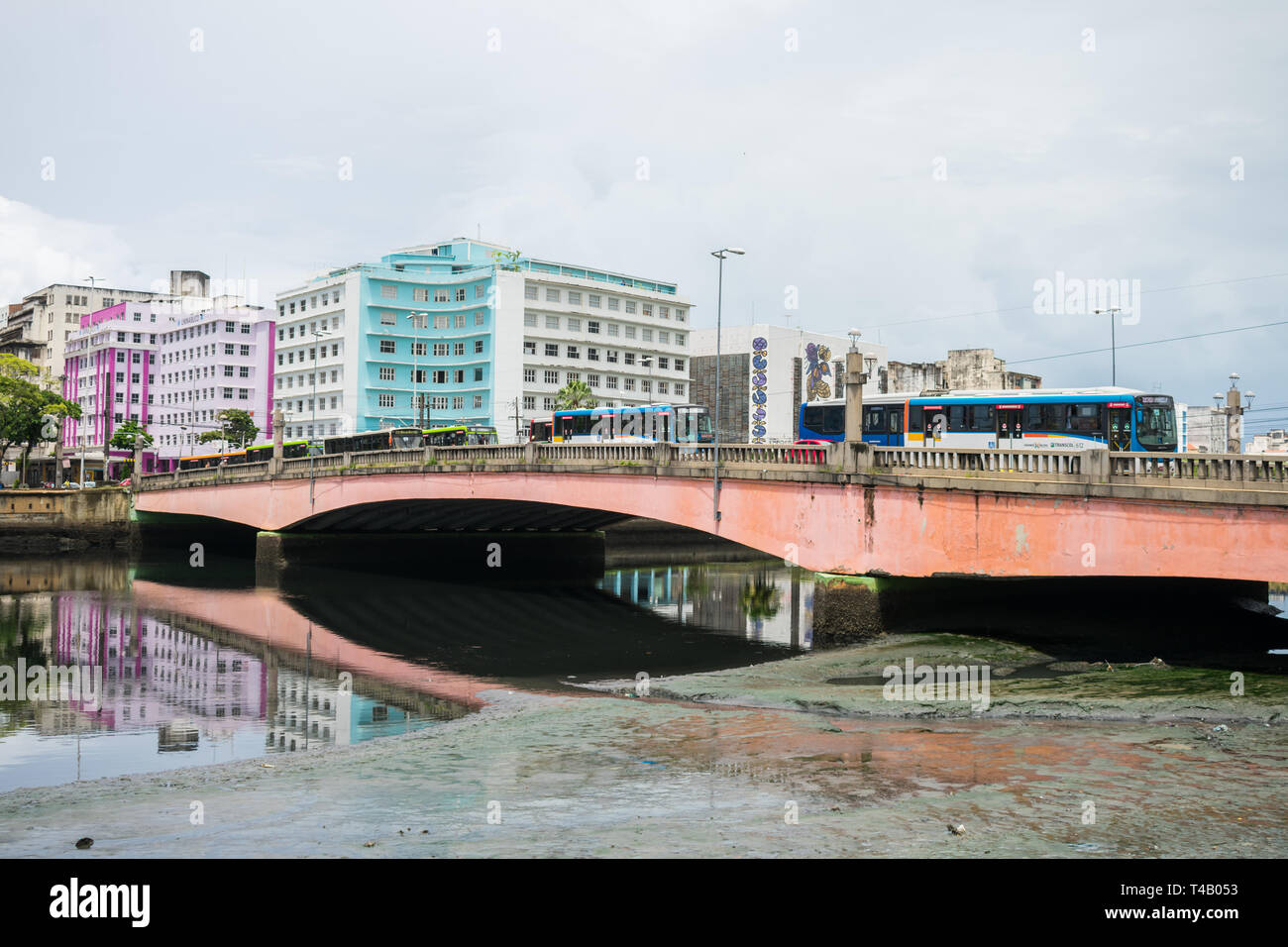 Recife, Brazil - Circa April 2019: Bridge full of buses and polluted river in the historic center of Recife Stock Photo