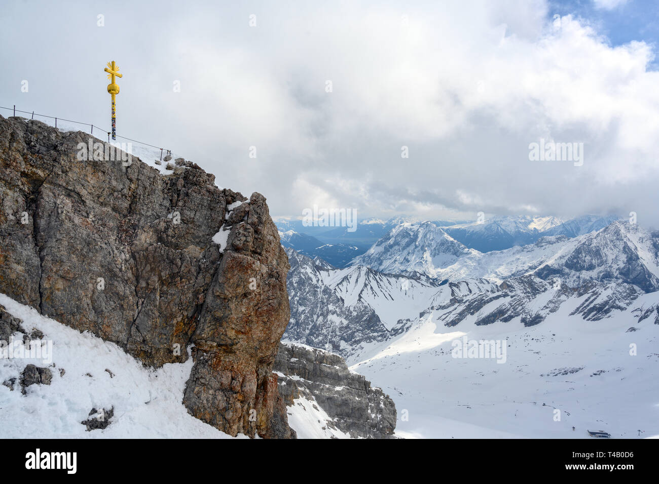 Summit cross on the Zugspitze, highest mountain of Germany in the snow covered Bavarian Alps near Garmisch Patenkirchen, copy space Stock Photo