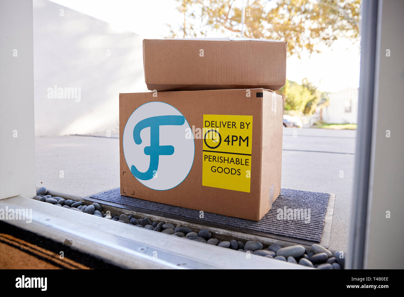 Fresh Food Home Delivery In Cardboard Boxes Outside Front Door Stock Photo