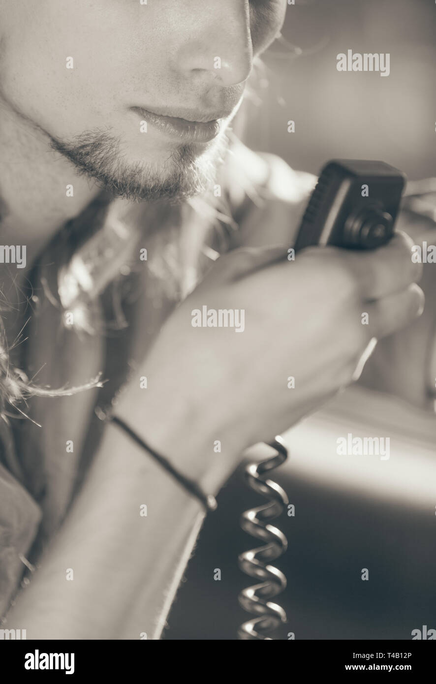 Talking while drive, auto walkie talkie, comunication concept. Young