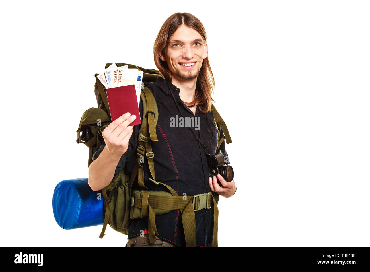 Man tourist backpacker holding passport full of money. Young guy hiker