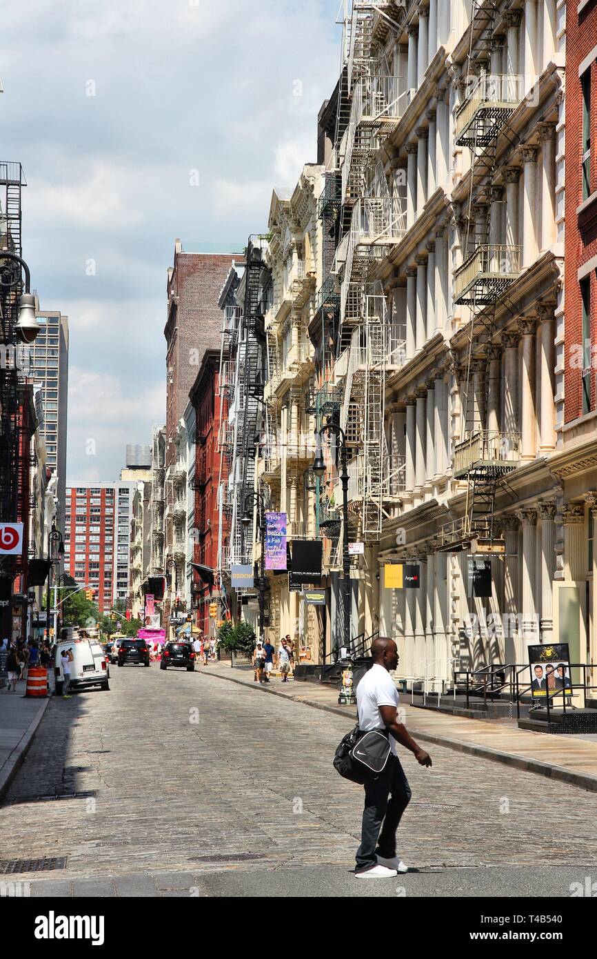 NEW YORK, USA - JULY 5, 2013: People visit Greene Street in SoHo. New York City is visited by 56 million annual visitors (2014). 20 million people liv Stock Photo