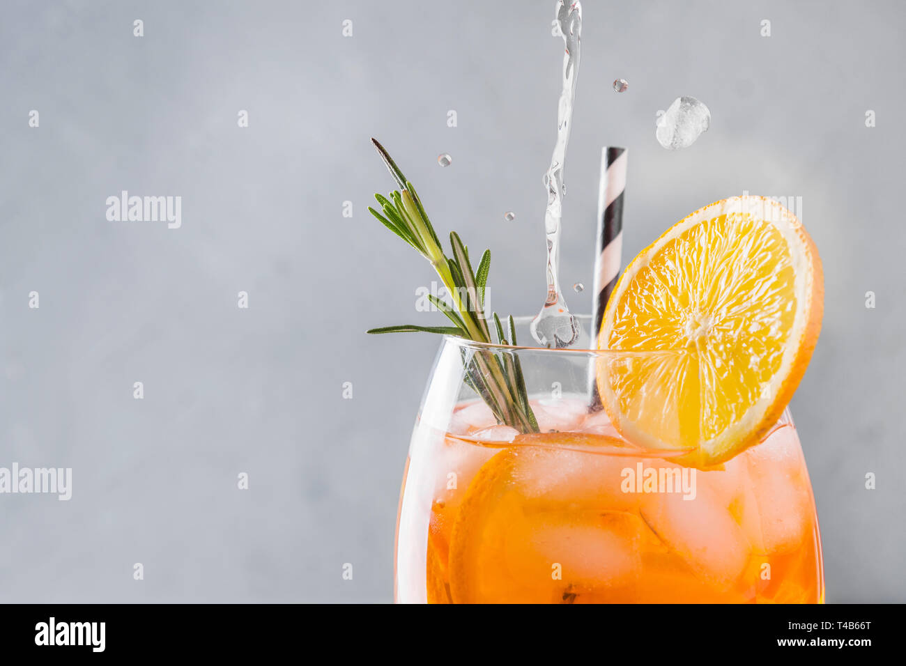 Classic Italian aperol spritz cocktail in wine glass on light. Close up. Stock Photo