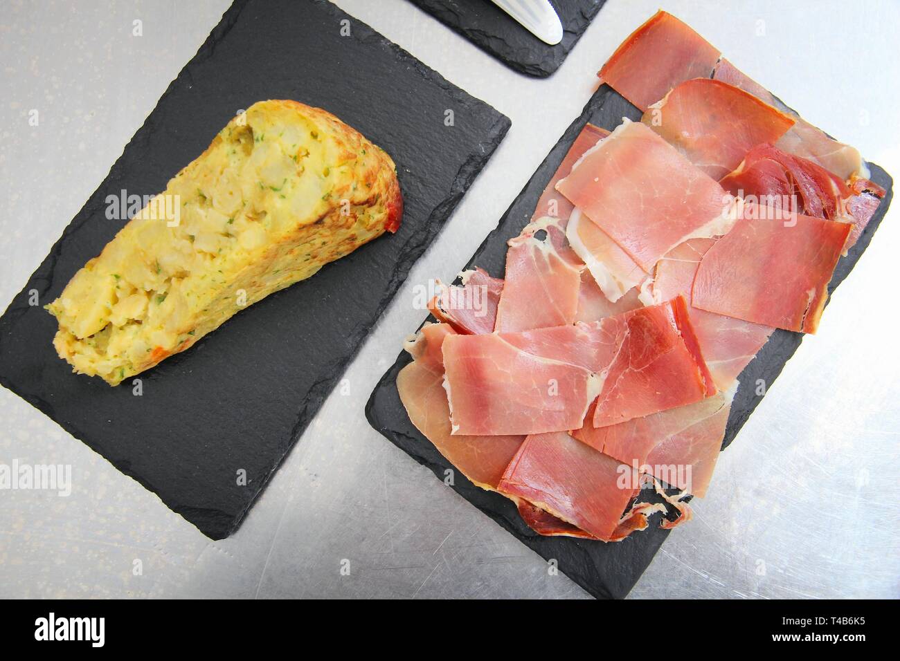 Spanish tapas served on black slate stones in Canary Islands tortilla
