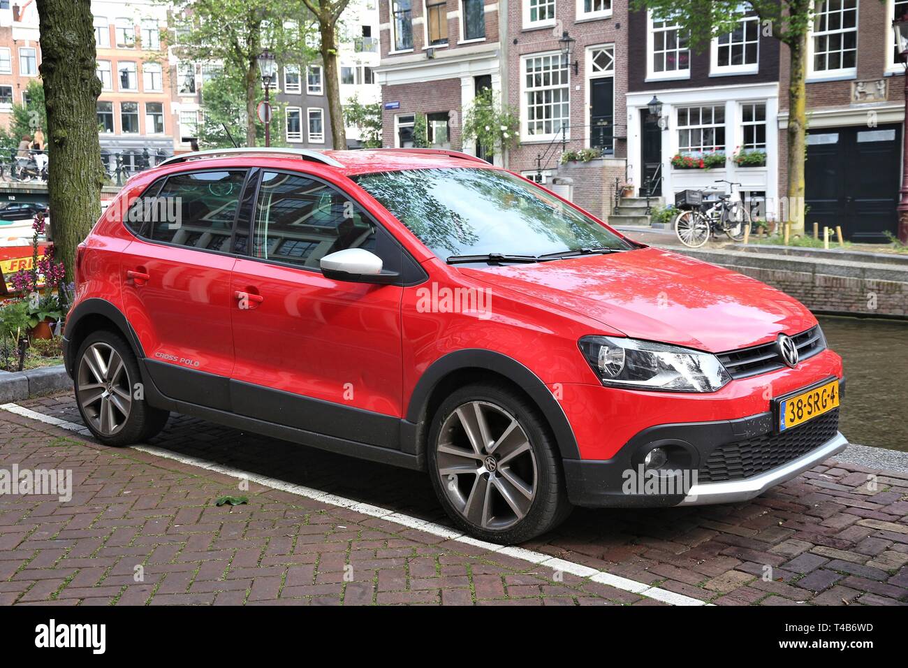 AMSTERDAM, NETHERLANDS - JULY 8, 2017: Red Volkswagen Polo Cross small city  car parked by the canal in Amsterdam. Netherlands has 528 registered cars  Stock Photo - Alamy