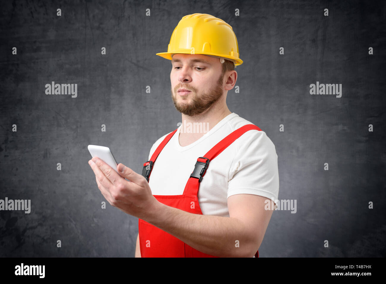 Construction worker using smartphone Stock Photo