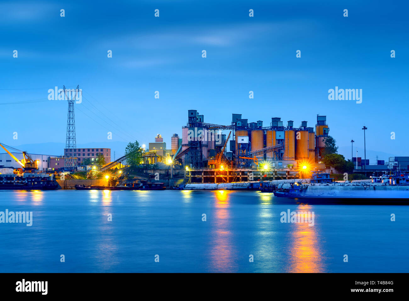 Riverside cement factory in the evening sky Stock Photo - Alamy