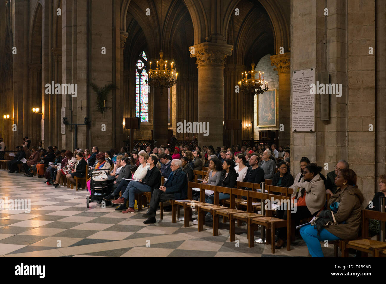 Paris, France - March 31, 2019: parishioners in the cathedral Notre Dame de Paris. Stock Photo