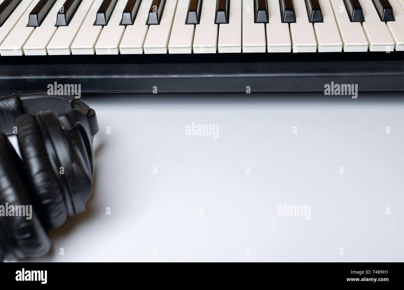 Piano keys and headphones with copy space, isolated. Synthesizer