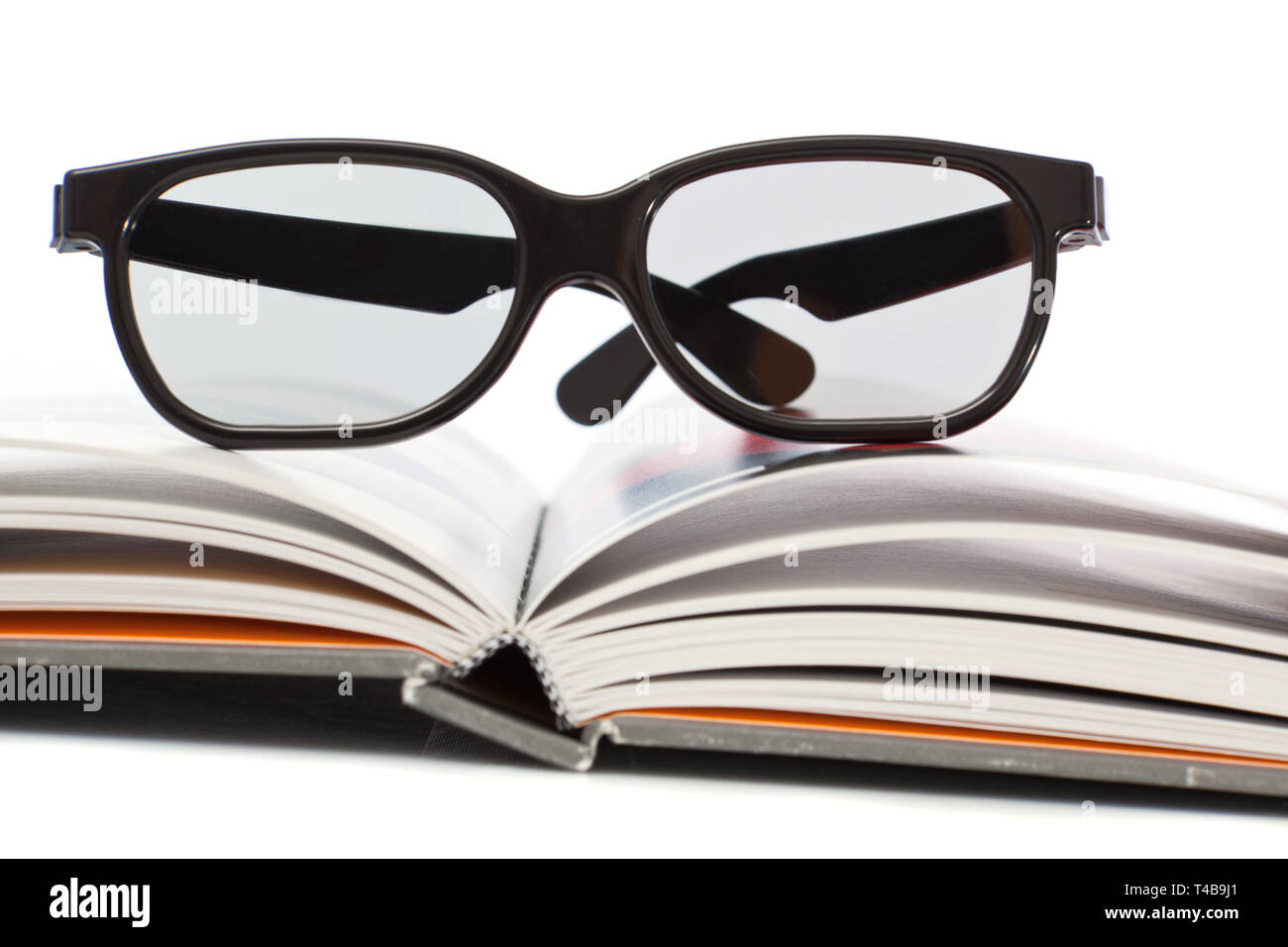 Spectacles lying on open book Stock Photo Alamy