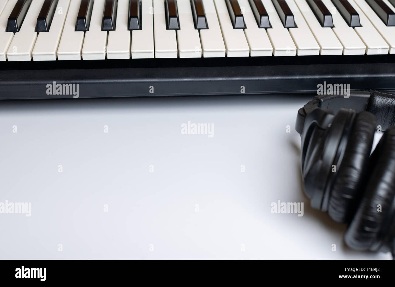 Piano keys and headphones with copy space, isolated. Synthesizer