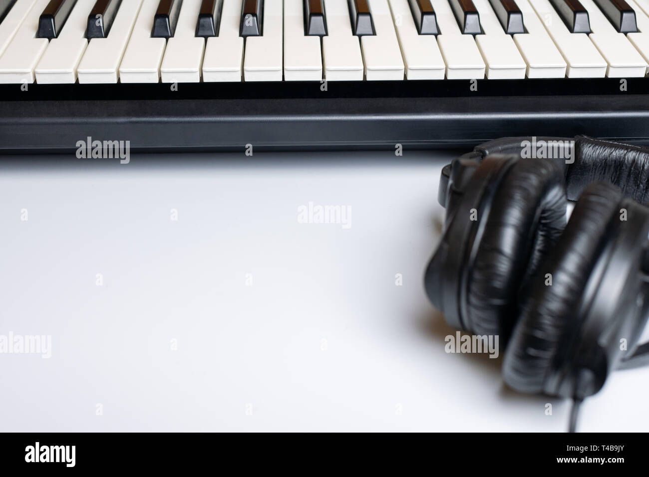 Piano keys and headphones with copy space, isolated. Synthesizer