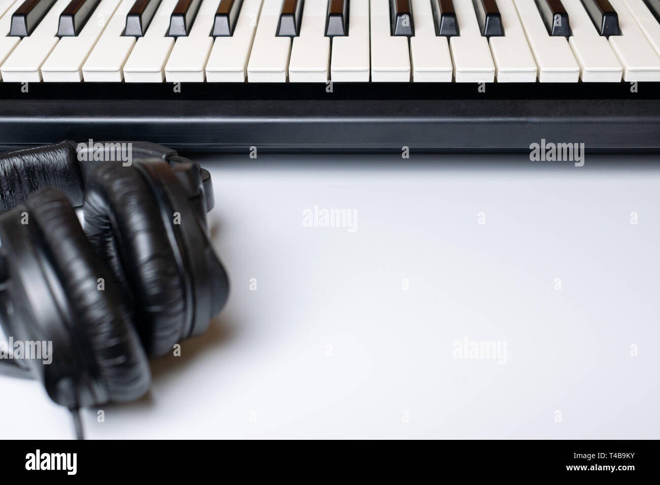 Piano keys and headphones with copy space, isolated. Synthesizer