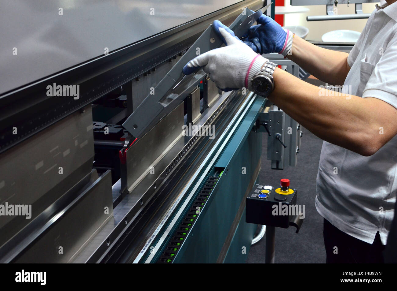 The process of bending sheet metal on a sheet bending machine Stock