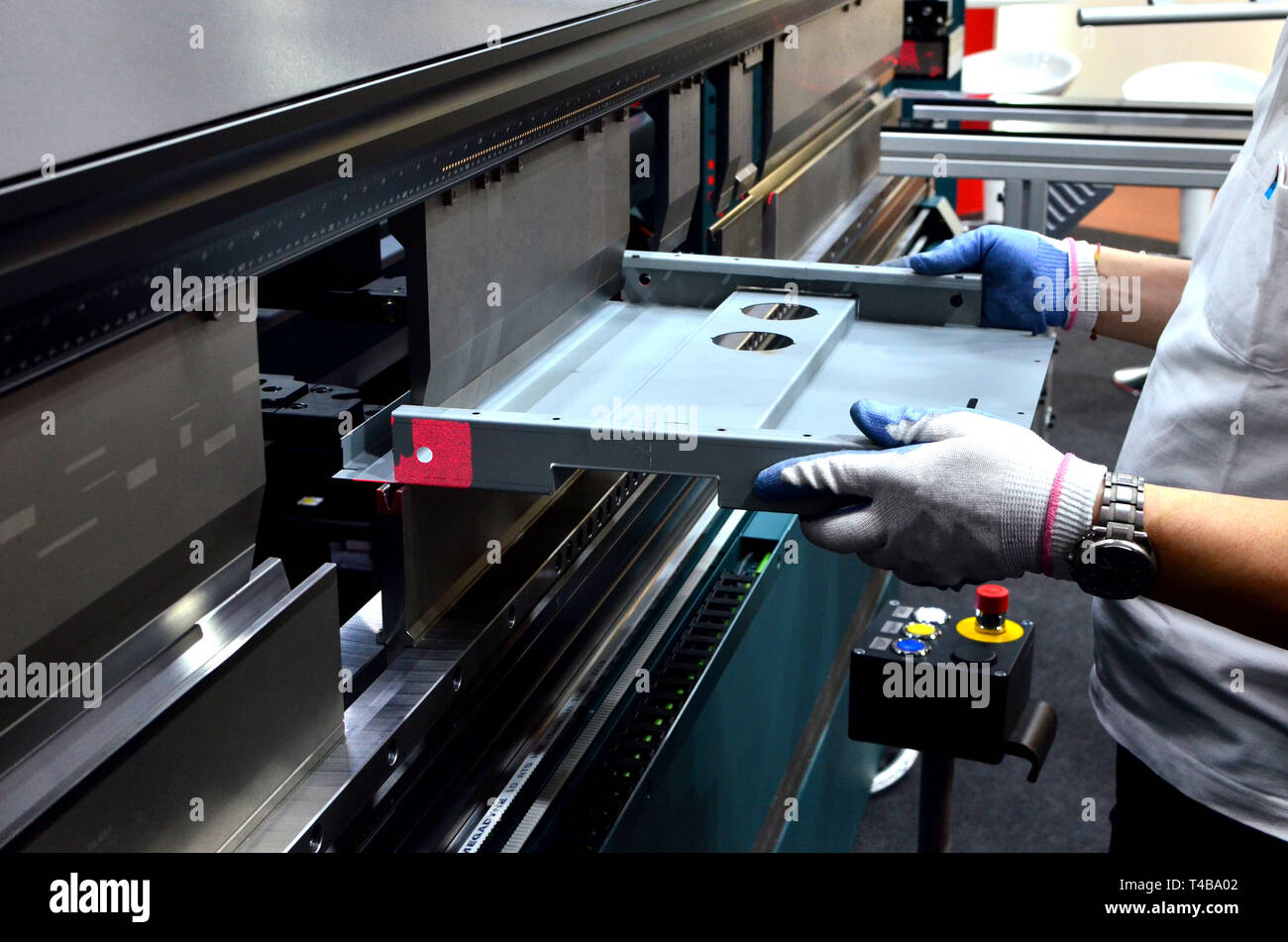 Working operator at a manufacturing plant bending sheet metal on a