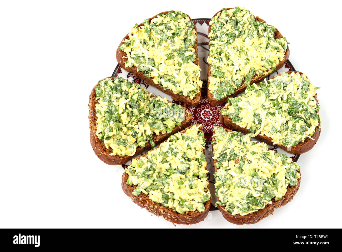 Hot sandwiches with wild garlic, green onions, eggs, cheese and parsley located on white