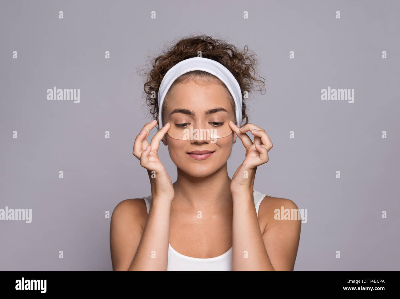 A portrait of a young woman with collagen pads in a studio, beauty and skin care. Stock Photo