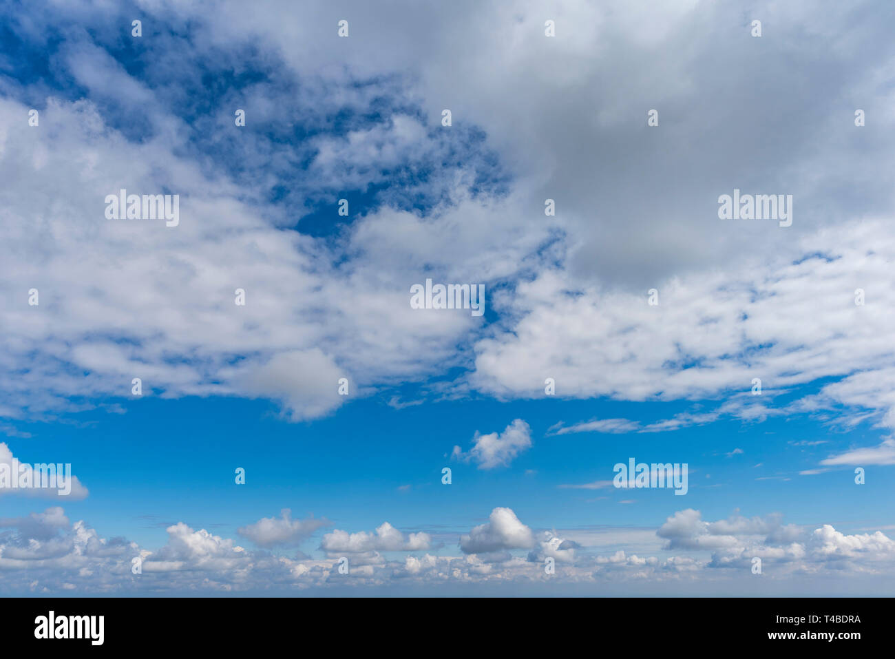 Blue sky with white puffy clouds Stock Photo - Alamy