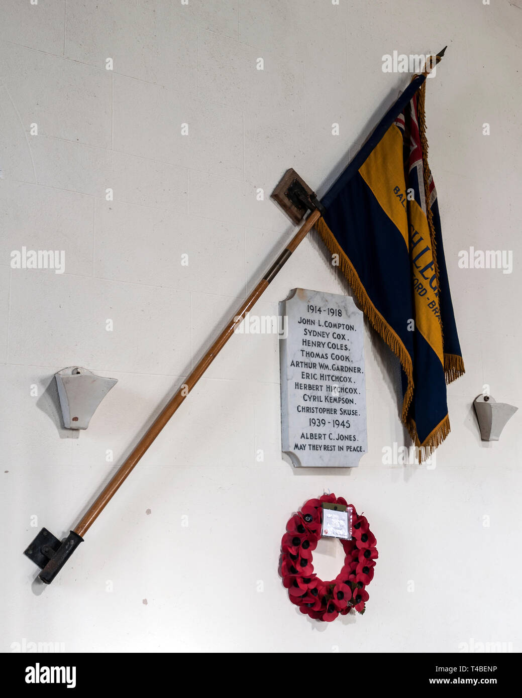 War memorial plaque and British Legion flag, St. Mary Magdalene Church, Balscote, Oxfordshire, England, UK Stock Photo