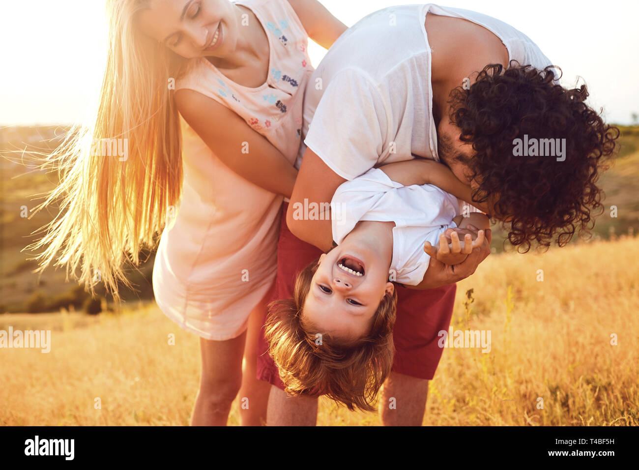 Happy family having fun playing in nature. Stock Photo